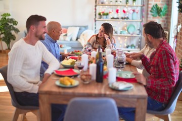 Beautiful family smiling happy and confident. Eating roasted turkey celebrating Christmas at home