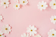 Leinwandbild Motiv Minimal styled concept. White daisy chamomile flowers on pale pink background. Creative lifestyle, summer, spring concept. Copy space, flat lay, top view.