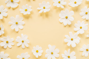 Wall Mural - Minimal styled concept. Wreath made of white daisy chamomile flowers on pale yellow background. Creative lifestyle, summer, spring concept. Copy space, flat lay, top view.