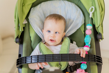 cute baby girl sitting in the stroller