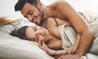 © Alessandro Biascioli - Happy couple having fun on bed under blanket - Young romantic lovers intimate moments - Intimacy and love relationship concept