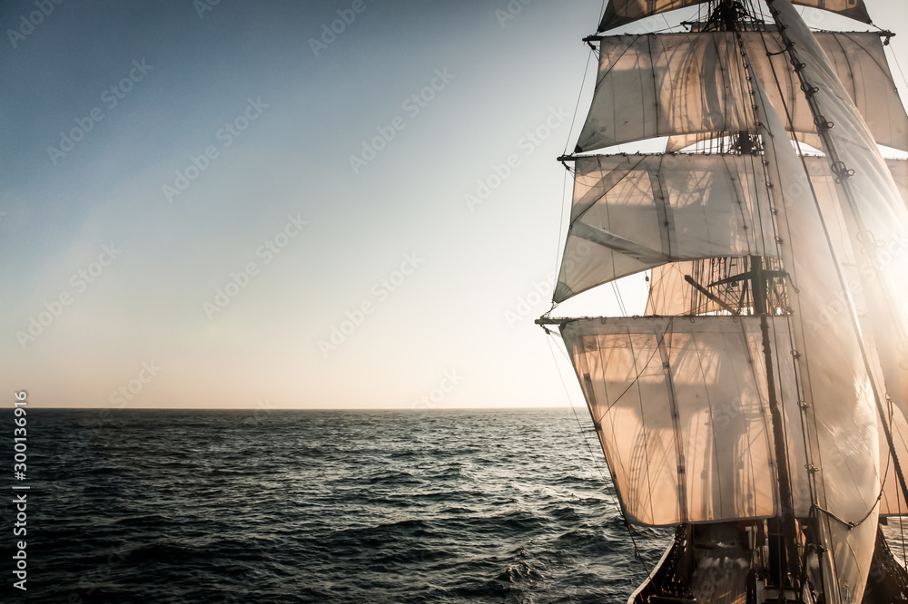 Backlit sails of a traditional tall ship on the atlantic - obrazy, fototapety, plakaty 