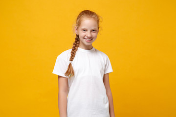 smiling little ginger kid girl 12-13 years old wearing white t-shirt isolated on bright yellow backg