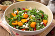 © nesavinov - Autumn salad with baked pumpkin, arugula, seeds, dried cranberries and feta cheese in bowl on rustic wooden background. Selective focus.