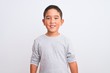 © Krakenimages.com - Beautiful kid boy wearing grey casual t-shirt standing over isolated white background with a happy and cool smile on face. Lucky person.