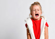 Portrait of crying, yelling, abused kid girl after family conflict. Family conflict, violence