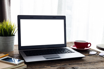 Mockup blank screen computer on a wooden desk. Notebook empty white screen on table