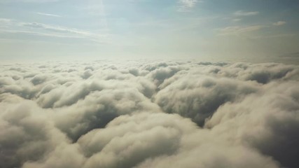 fly on the clouds with the morning sun clouds move gently in the sky and sun light.