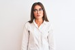 © Krakenimages.com - Young beautiful businesswoman wearing glasses standing over isolated white background looking sleepy and tired, exhausted for fatigue and hangover, lazy eyes in the morning.