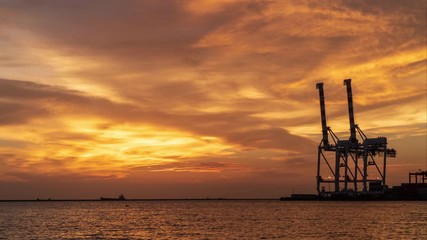 Wall Mural - Container ship unloading in the sunset, time lapse