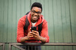 smiling young african american man with glasses and mobile phone