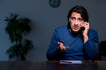 Young convict man sitting in dark room