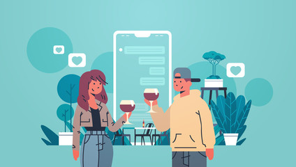 Man woman drinking wine couple using mobile