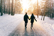 © prochkailo - Couple Holding Hands Walking Away. Winter, Sunny, Forrest, Recreation, Leisure, Clothing.