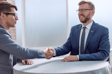 Wall Mural - close up. business handshake over the office Desk.