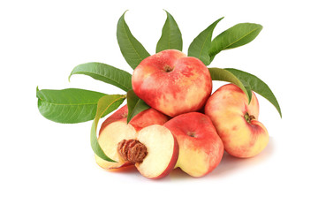 Wall Mural - Flat fig peaches with a half and with leaves isolated on white