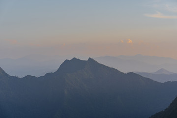 Wall Mural - High angle viewpoint sunset over mountains and forest