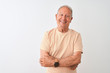 © Krakenimages.com - Senior grey-haired man wearing striped t-shirt standing over isolated white background happy face smiling with crossed arms looking at the camera. Positive person.