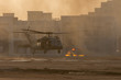 © KingmaPhotos - Military combat and war with helicopter landing in the chaos and destruction. Smoke and fire on the ground. Military concept of power, force, strength, air raid.