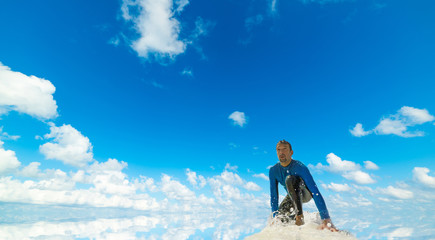 Wall Mural - Surfer under a blue sky with clouds