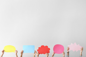 Female hands with speech bubbles on white background