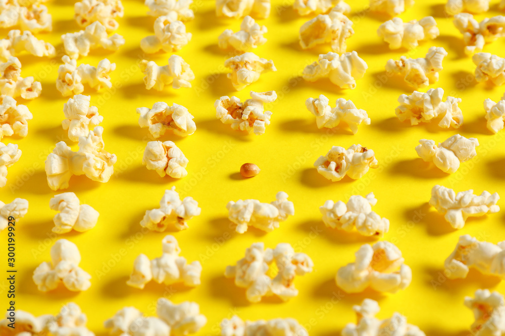 Many popcorn and one kernel on color background. Concept of uniqueness