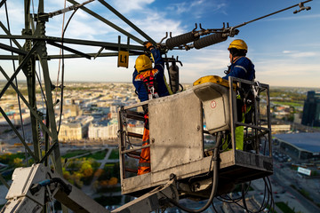 Electrical engineer repairing the electrical network on an elevation boom