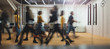Leinwandbild Motiv Businesspeople walking at modern office. Group of business employees at coworking center. Motion blur. Concept work process. Wide image