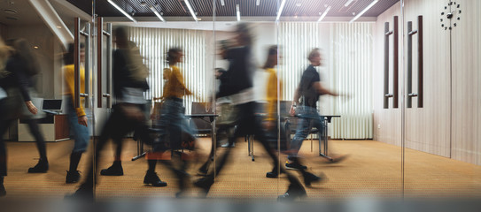 businesspeople walking at modern office. group of business employees at coworking center. motion blu