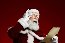 Waist Up Portrait Of Classic Santa Reading List On Parchment Standing Against Red Background, Copy Space