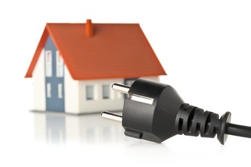 Wall Mural - power cord with model house on white - energy saving or power consumption concept