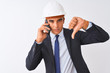 © Krakenimages.com - Young architect man wearing helmet talking on smartphone over isolated white background with angry face, negative sign showing dislike with thumbs down, rejection concept