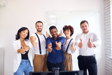 Wall Mural - Smiling team portrait of diverse interracial business group standing in office, white background, thumb