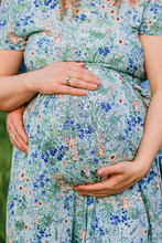 Maternity Photo Of A Pregnant Woman Holding Her Baby Bump Belly