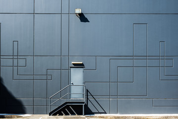 Clean geometric shapes of industrial architecture - back door entrance into warehouse building