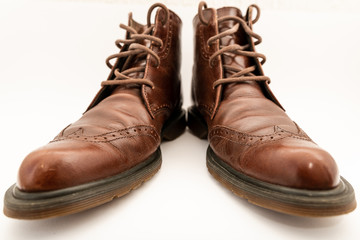 Vintage brown boots on white background, retro shoes