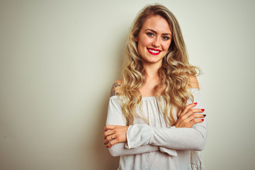 Sticker - Young beautiful woman standing over white isolated background happy face smiling with crossed arms looking at the camera. Positive person.