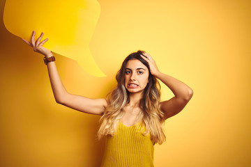 Sticker - Young beautiful woman holding speech bubble over yellow isolated background stressed with hand on head, shocked with shame and surprise face, angry and frustrated. Fear and upset for mistake.