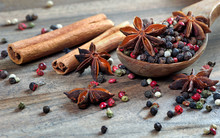 Traditional Spices. Mix Of Peppers In A Wooden Spoon, Anise Stars And Cinnamon On A Wooden Table