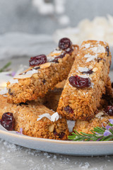 Wall Mural - Granola bar. Healthy snack. Cereal granola bar with nuts, fruit, coconut and cranberries on a christmas table