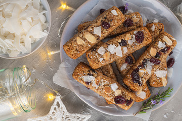 Wall Mural - Granola bar. Healthy snack. Cereal granola bar with nuts, fruit, coconut and cranberries on a christmas table. Top view