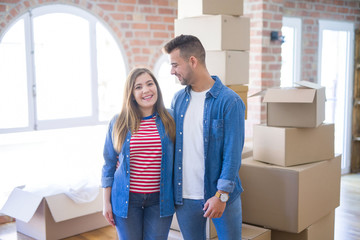 Wall Mural - Young beautiful couple in love moving to new home, very happy and cheerful for new apartment