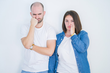 Canvas Print - Young couple together over white isolated background thinking looking tired and bored with depression problems with crossed arms.