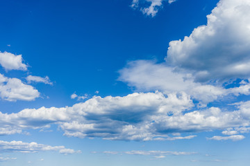 Blue sky on a sunny day with fluffy clouds