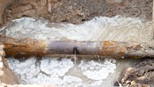 Close-up Of Leakage In City Sewage System Ot Water Pipeline. Water Coming From Broken Metallic Tube. 4k UHD Video Footage