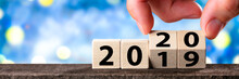 Hand Changing Date From 2019 To 2020 On Wooden Cube Calendar / New Year's Concept