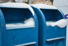 Blue Mailboxes With Snow On Them