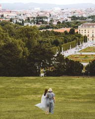 two women walking down a green hill