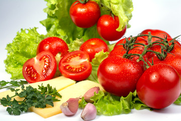 cherry tomatoes on lettuce leaves on white background