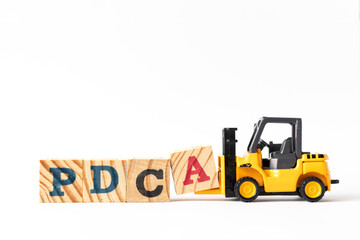 Sticker - Toy forklift hold wood letter block a to complete word PDCA (Plan, Do, Check, Act) on white background